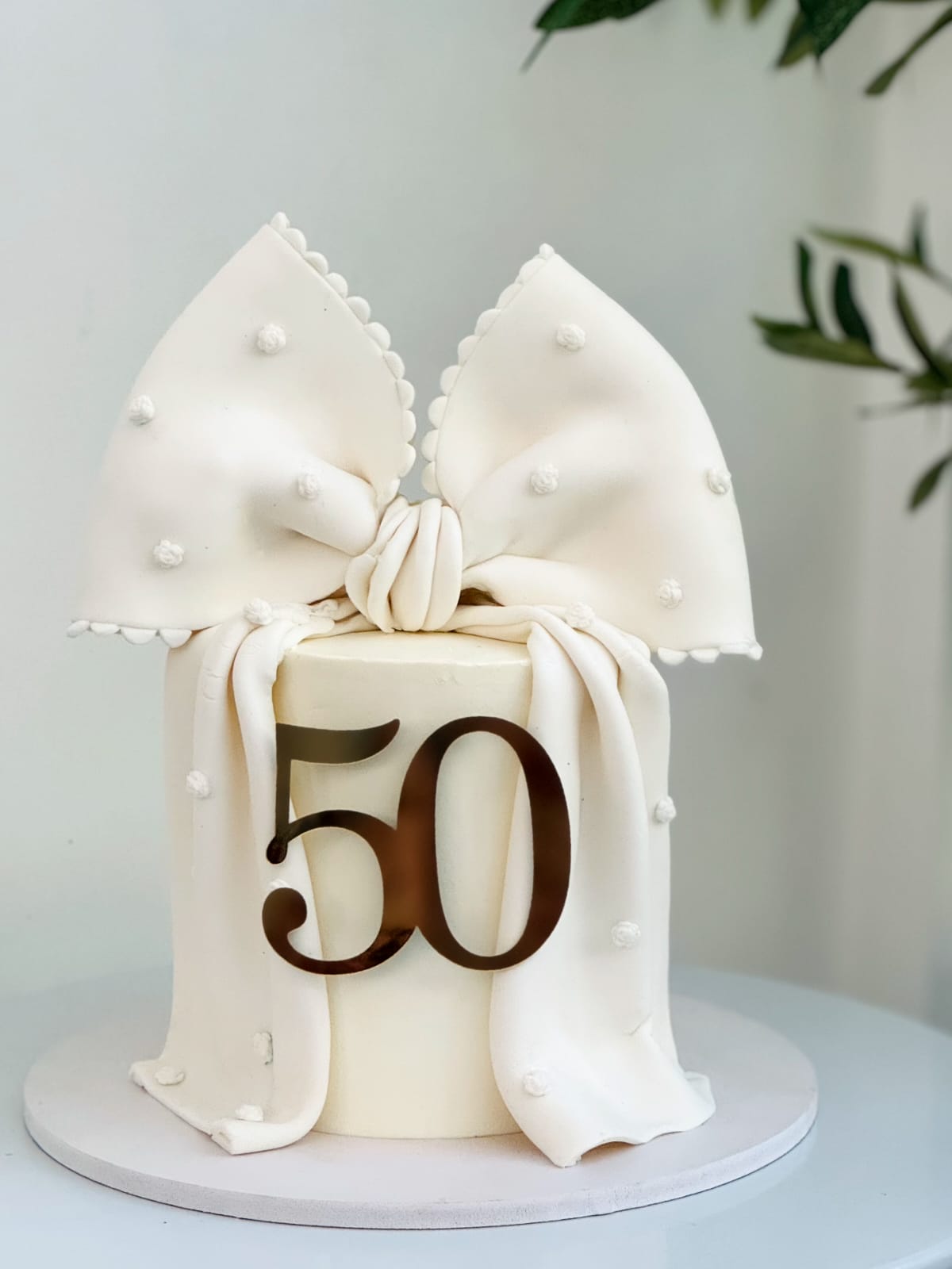 Ivory milestone cake with 50 topper