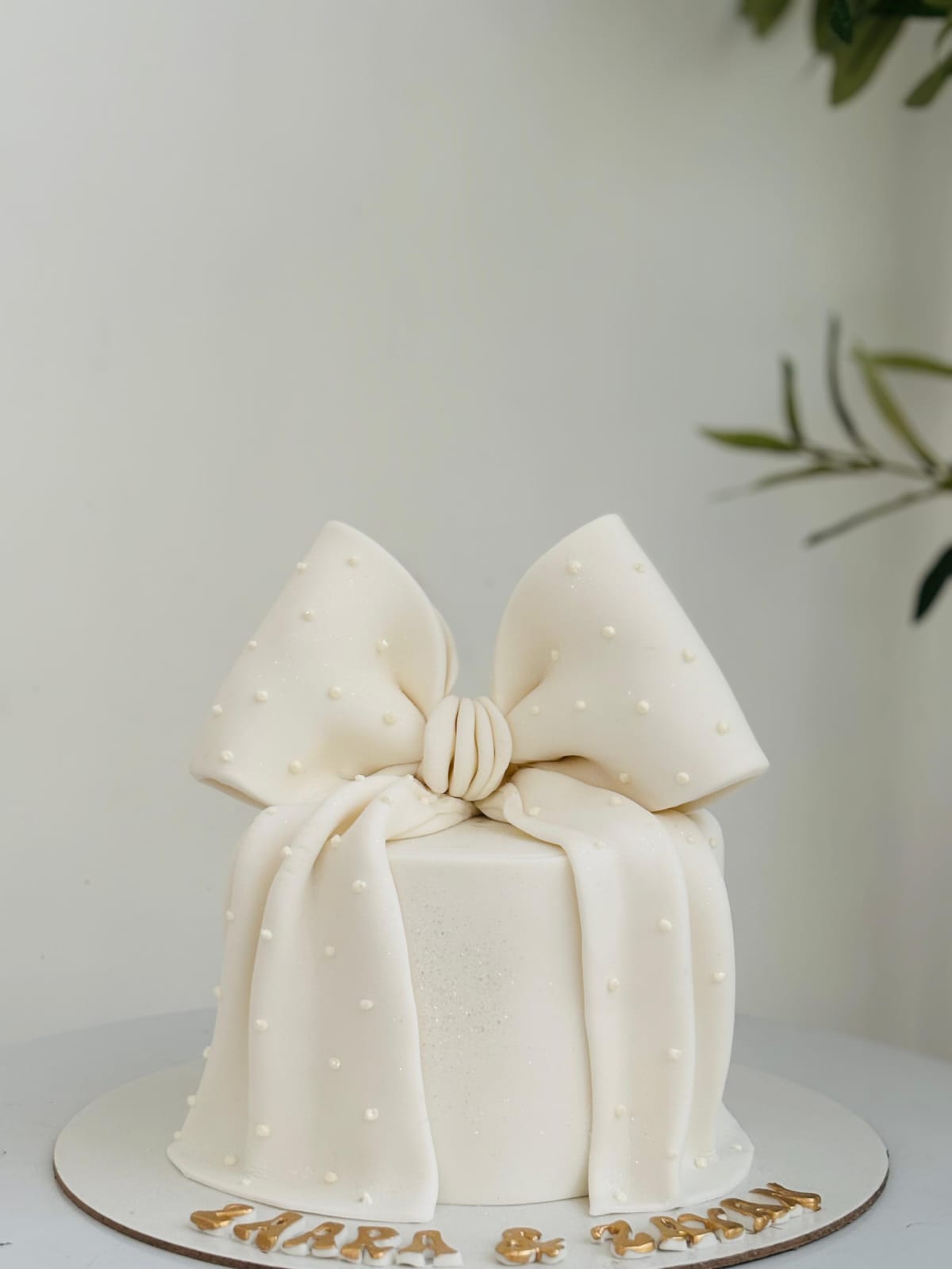 Ivory bow cake with pearl detailing