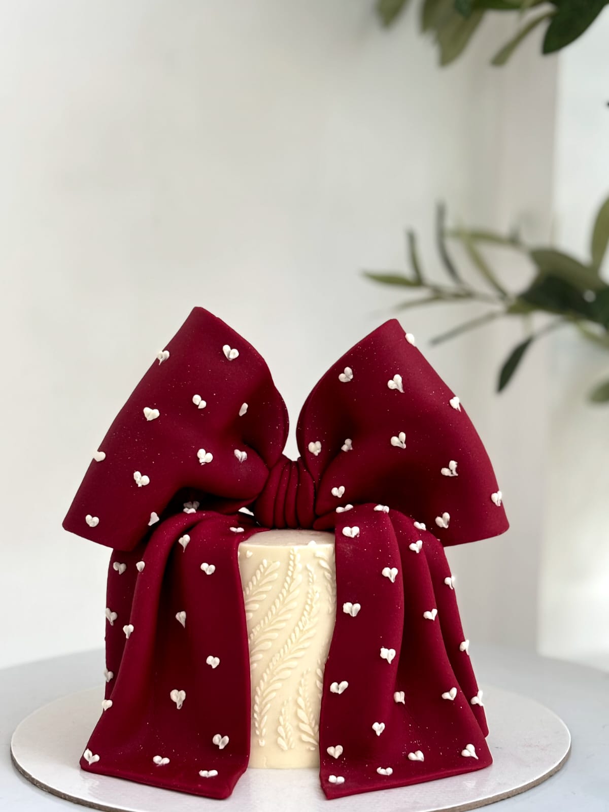 Deep ruby bow cake with heart motifs